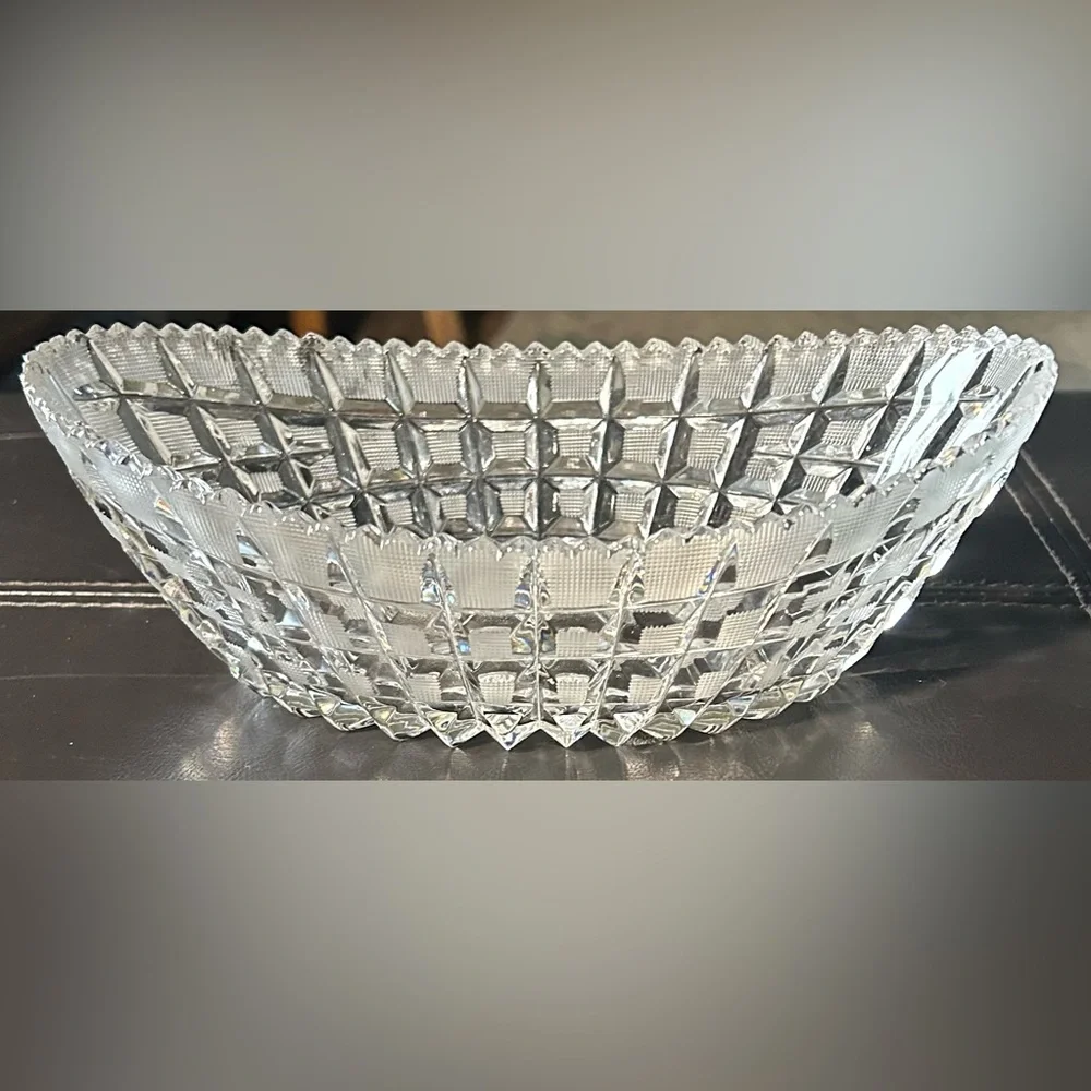 Vintage boat-shaped lead crystal bowl with a sawtooth edge and block pattern.